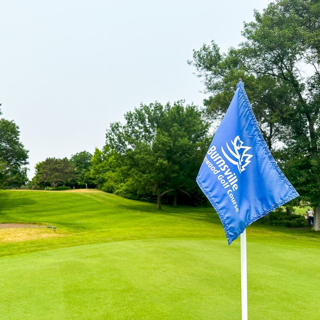 A Birnamwood Golf Course hole flag waving in the wind