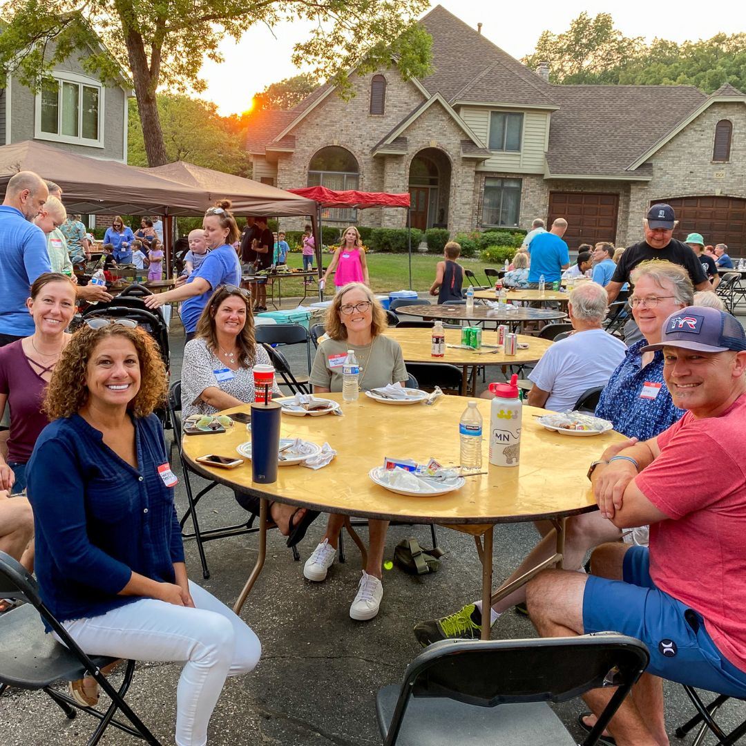 A group of neighbors gathered around a table at a Night to Unite party