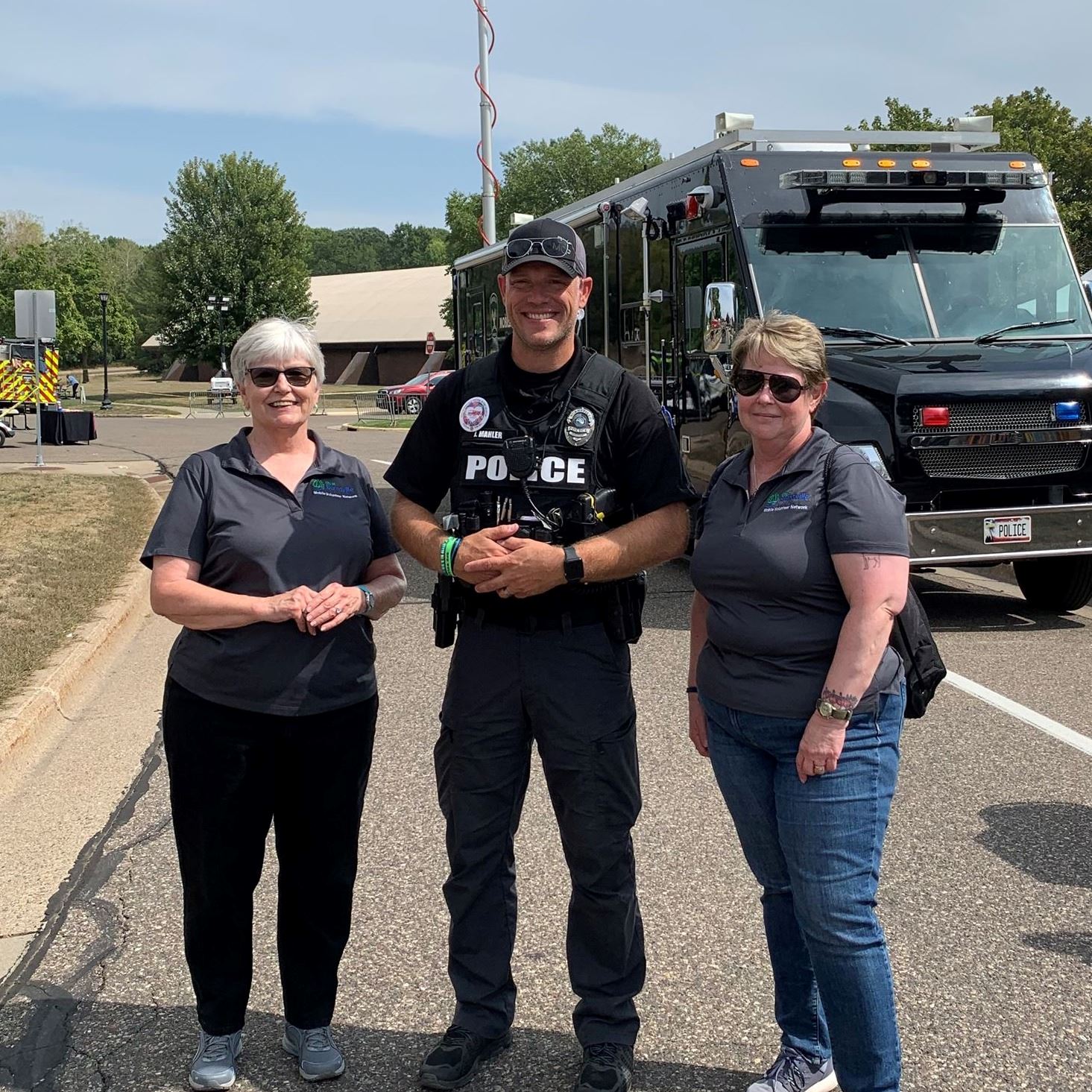 Volunteers and police officer at event
