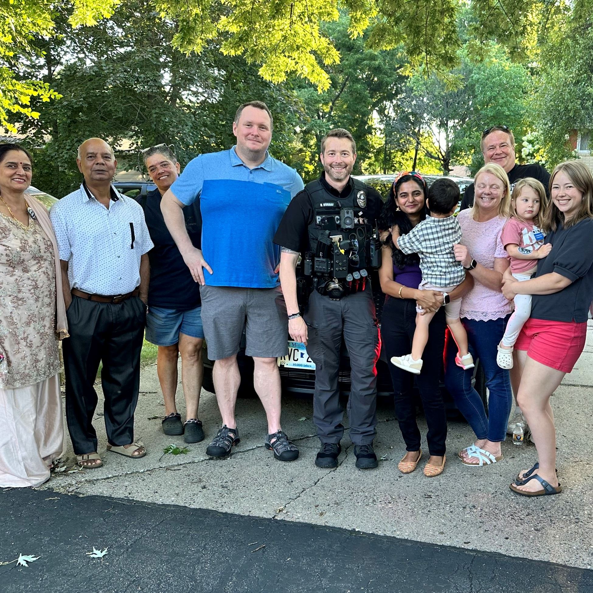 Group of people standing by police car