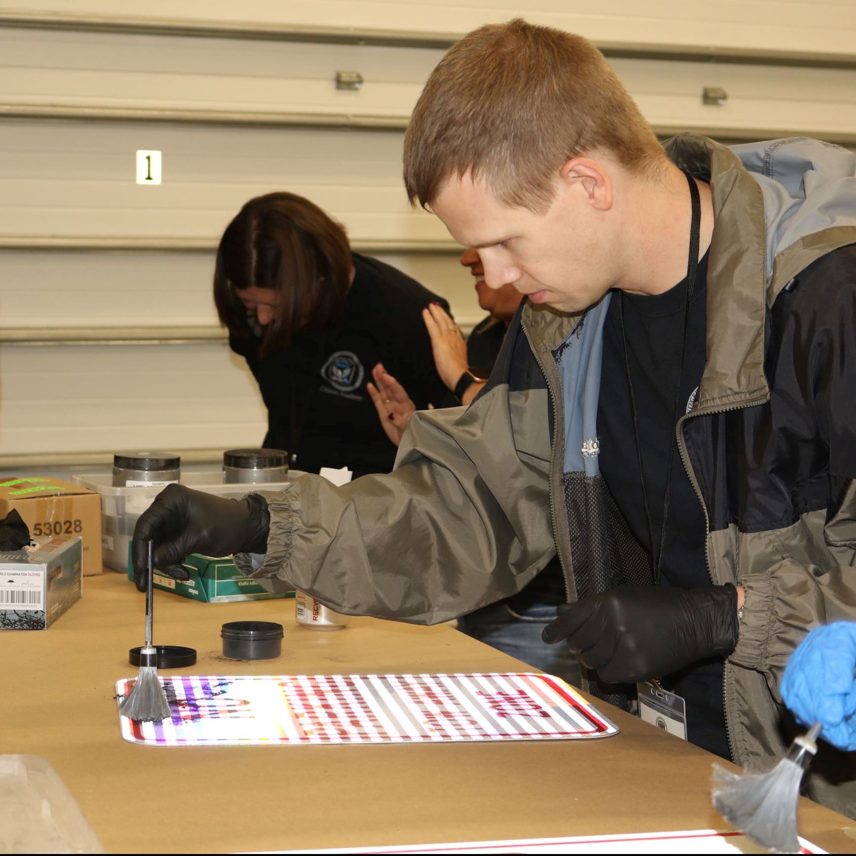 Citizens academy participant dusting for prints