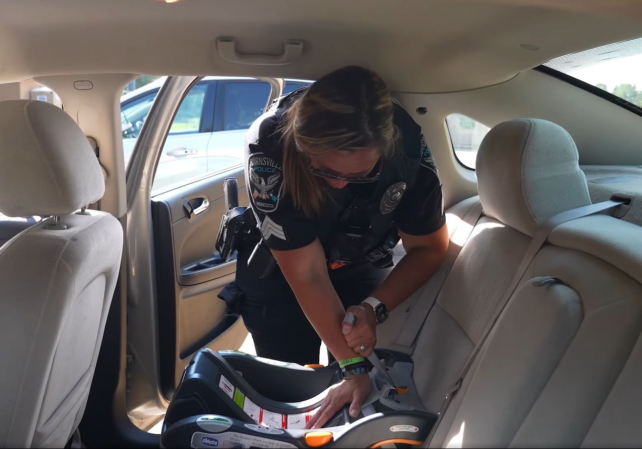 Police officer installs a car seat