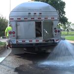 Water truck spraying water onto the ground