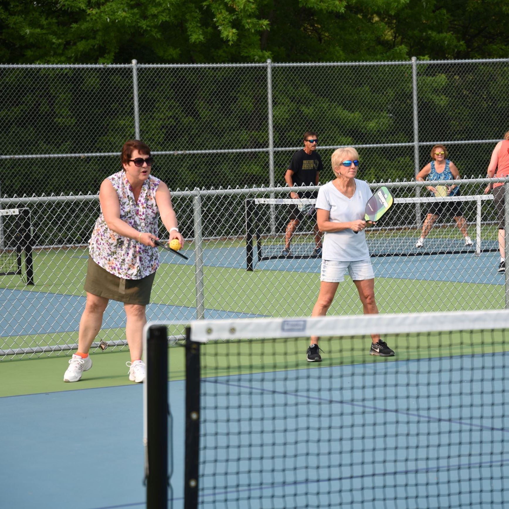 Two women playing pickleball