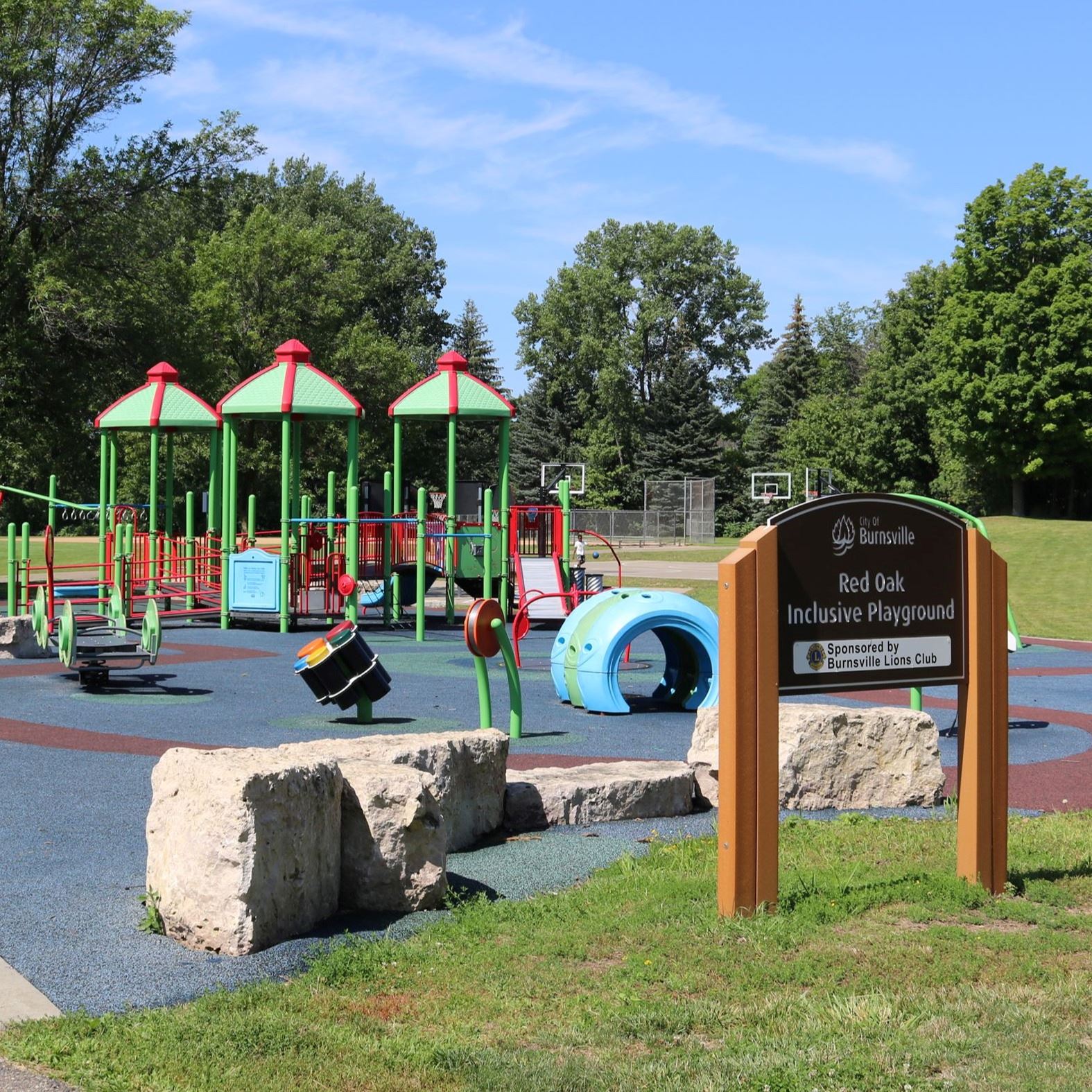 playground with inclusive ramps, swings and playsurface