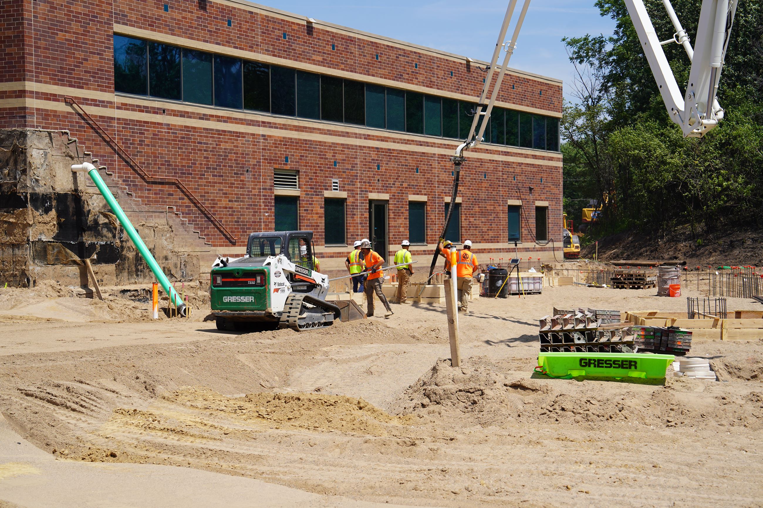 Construction workers pouring concrete into new foundation.